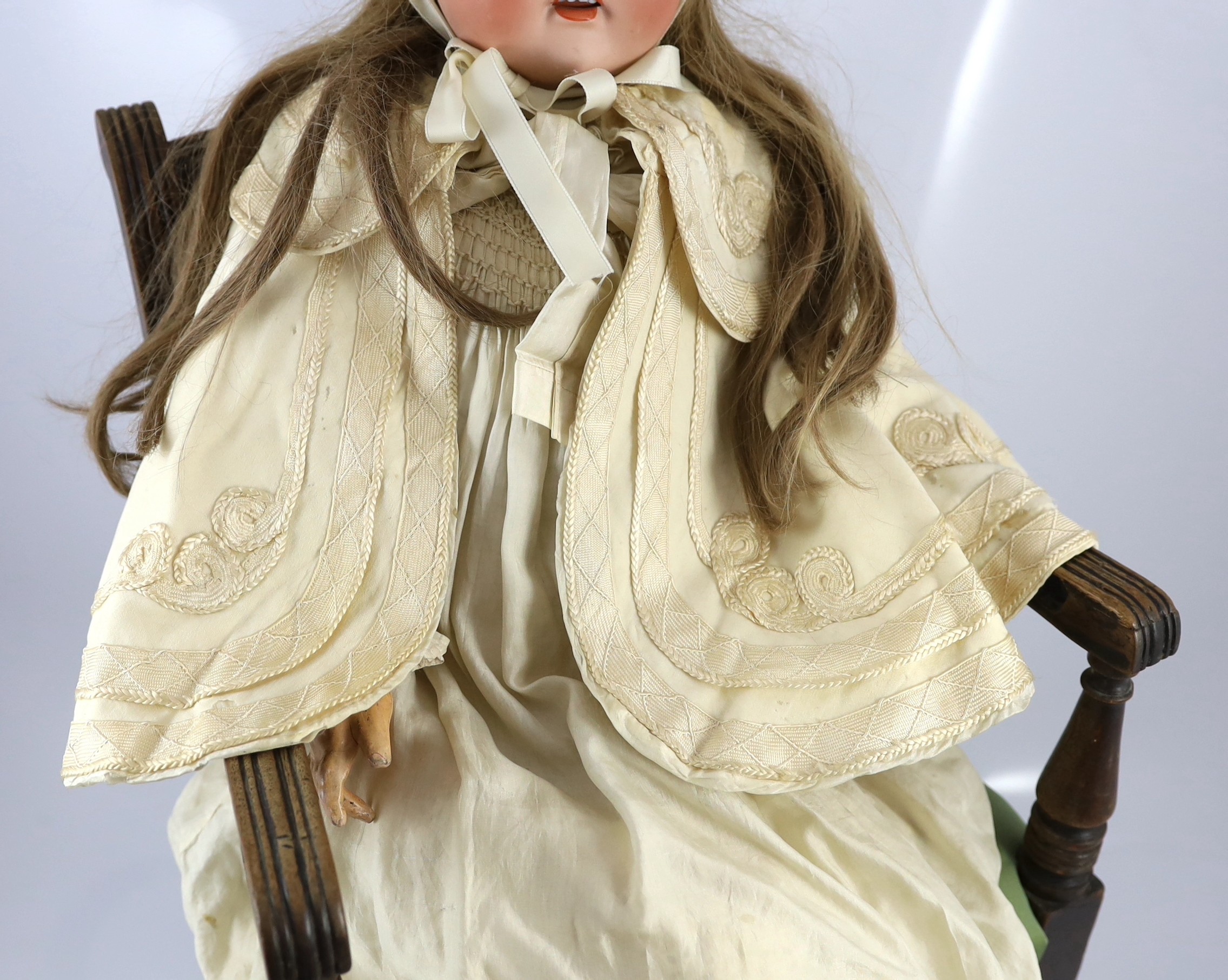 A J.D. Kestner large bisque doll, German, circa 1916, 31in. Please note the chair is for display purposes only.